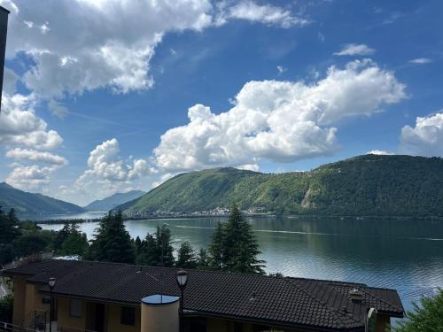 a view of a large body of water with mountains at La Maison du Lac in Bissone
