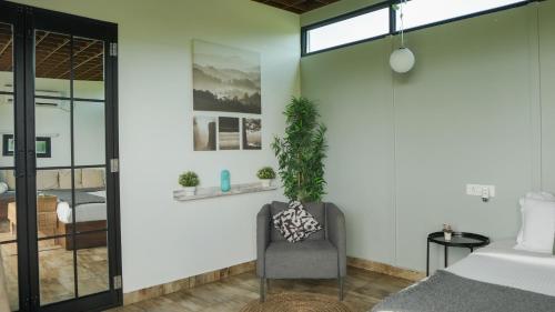 a bedroom with a chair and a bed at Fargo Porch in Bībīnagar