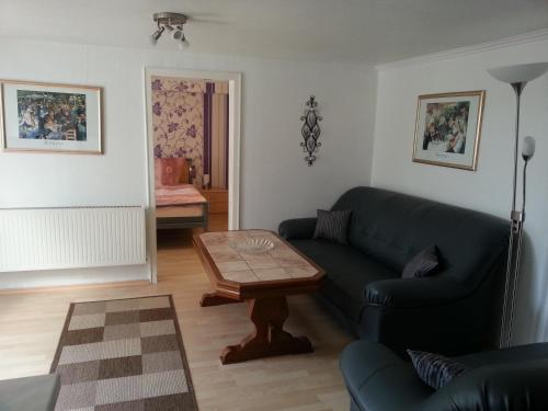a living room with a couch and a coffee table at Ferienwohnungen Angela in Bad Marienberg