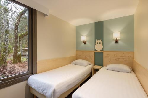Ένα ή περισσότερα κρεβάτια σε δωμάτιο στο Center Parcs Les Hauts de Bruyères