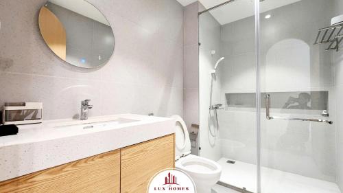 a bathroom with a toilet and a sink and a shower at The LuxHomes Apartment ᵀᴹ I HOT Độc Đáo Nhất Vinhomes Marina in Hai Phong