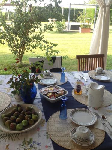a table with plates and bowls of food on it at BED & BREAKFAST Orizzonte in Caorle