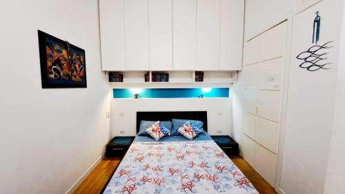 a bedroom with a bed in a room with white cabinets at Coral & Turquoise in Pozzuoli