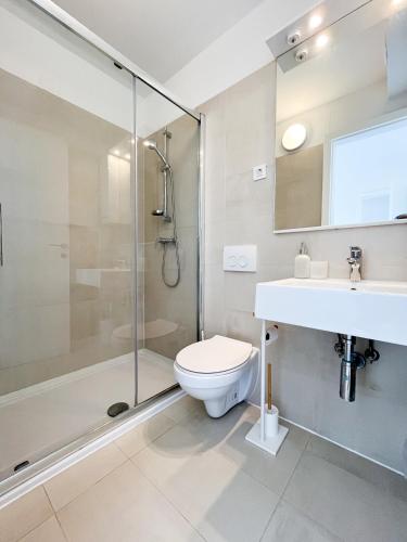 a bathroom with a shower and a toilet and a sink at Sea Around in Povljana
