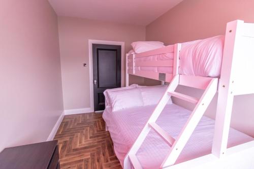 a bedroom with two bunk beds and a hallway at Eden House and Pet Farm in Feevaghmore