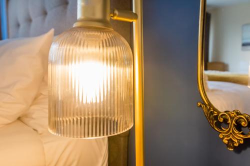 a close up of a lamp next to a bed at Prebends Field in Gilesgate
