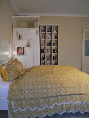 a bedroom with a bed and a book shelf at Altstadthaus Cityappartements in Graz