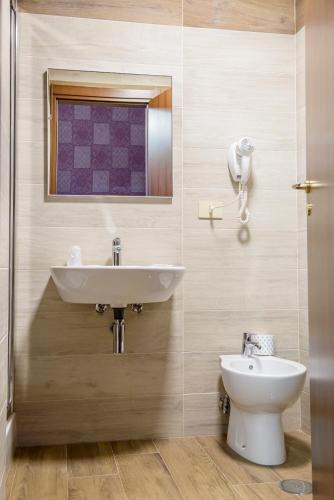 a bathroom with a sink and a toilet at Hotel Emmaus in Rome