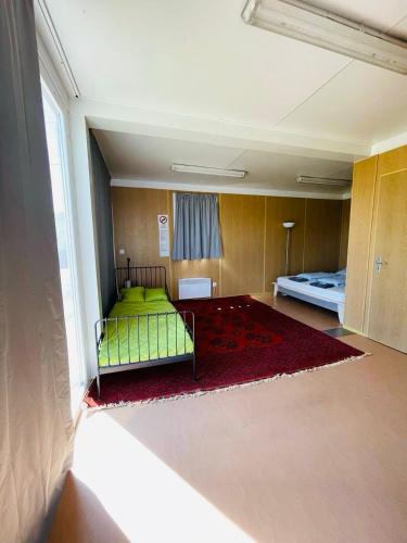 a bedroom with a green bed in a room at GreenPark Tiny House, Garden Terrace & Parking in Bekecs
