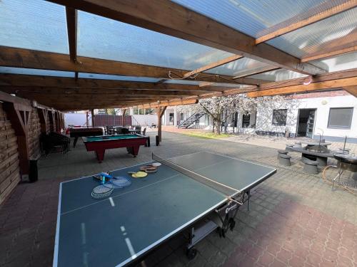 a ping pong table in a pavilion with a ping pong table at Sulyom Panzió in Tiszafüred
