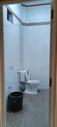 a bathroom with a toilet in a room at Bloom Home Stay in Tuk Tuk