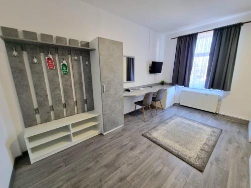 an empty room with a desk and a table and chairs at Filo Hotel Wellness & Spa in Gheorgheni