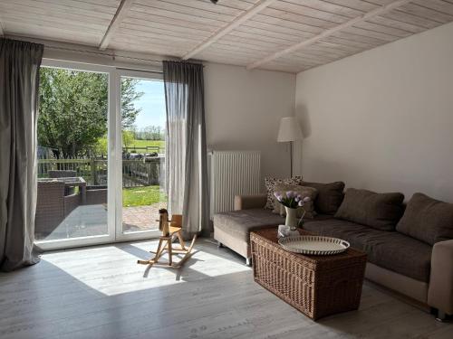 a living room with a couch and a table at Strandhof Holnis in Glücksburg