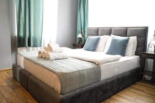 a bedroom with a large bed with teddy bears on it at Hotel Dum by Muskat in Belgrade