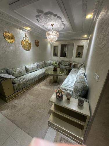 a living room with a couch and a table at Ahmed 205 in Temara