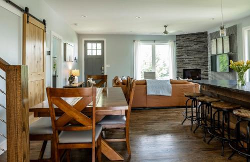 a kitchen and living room with a wooden table and chairs at Reynolds View in Asheville