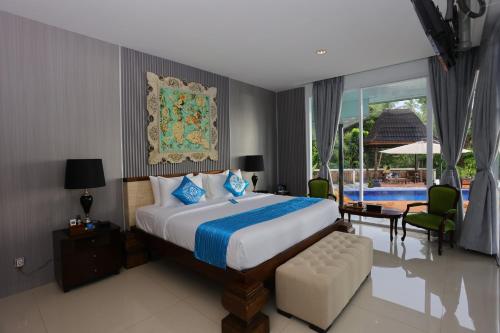a bedroom with a large bed and a pool at Nayara Villa Desa Budo in Wori