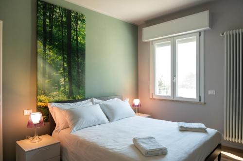 a bedroom with a bed with a large painting on the wall at Casa Isabella2 in Ferrara