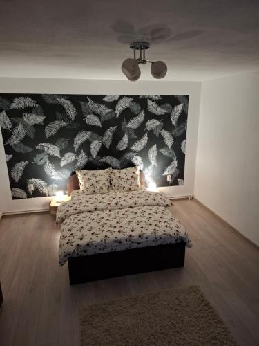 a bedroom with a bed and a large wall mural at Casa Szabo in Vaţa de Jos