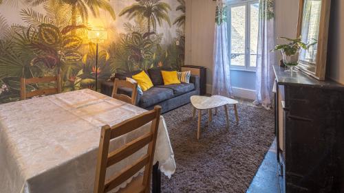 un salon avec une table et un canapé dans l'établissement Les Suites du Jardin 3 - Instant vole - Hypercentre, à Chaumont