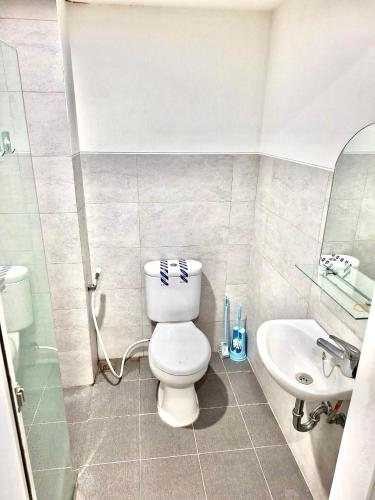 a bathroom with a toilet and a sink at Rouyame room by greenpark apartment in Seturan