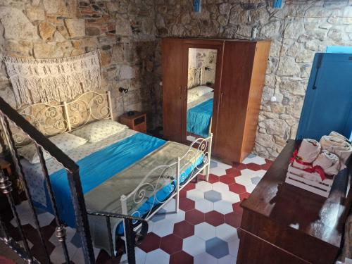 a bedroom with a bed and a mirror at Su Furriadroxiu in San Vito