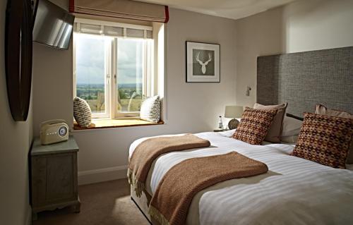 a bedroom with a large bed and a window at The Fish Hotel in Broadway