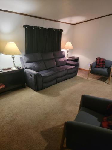 a living room with a couch and two chairs at Samburg get a Way in Hornbeak