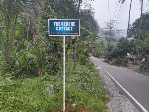 a sign on the side of a road at The Serene Cottage in Viripara