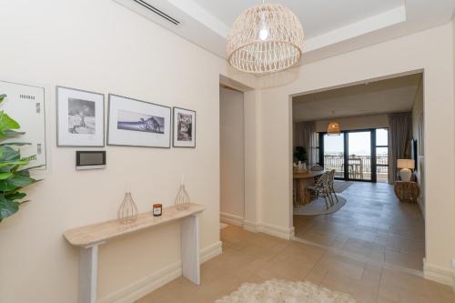 a living room with a table on the wall at Voyage Saadiyat Island Retreat in Abu Dhabi