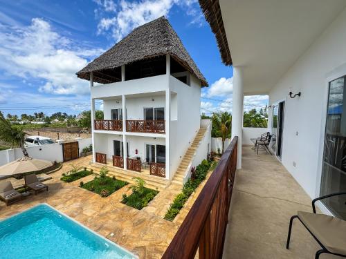 a villa with a swimming pool and a house at Villa Ramo in Kiwengwa