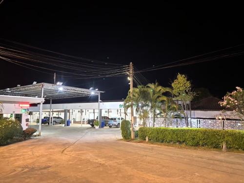 a gas station at night with cars parked in front at Garden Place in Phetchabun