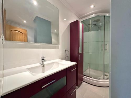 a bathroom with a sink and a glass shower at La Espina, en Somo - 30024 in Somo