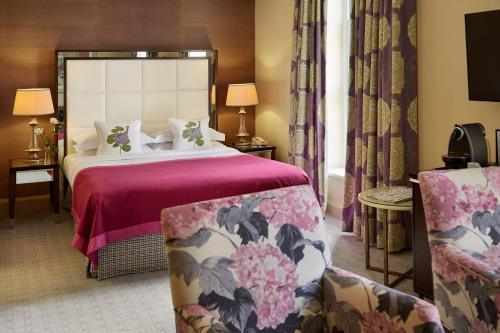 a hotel room with a bed and two chairs at The Mandeville Hotel in London