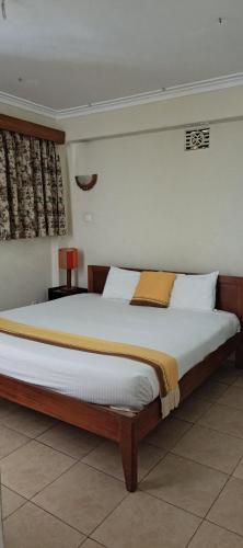 Ένα ή περισσότερα κρεβάτια σε δωμάτιο στο Kenya Comfort Hotel