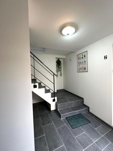 a staircase in a house with a tile floor at Le clos du 4 in Épernay