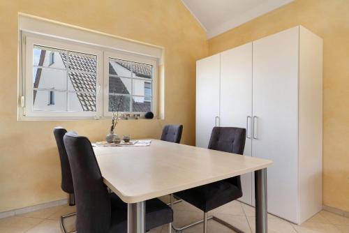 a dining room with a table and chairs at Gästesuite in Kehl am Rhein