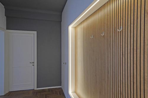 a room with a large closet with a white door at Hotel Spiaggia d'Oro - Charme & Boutique - Garda Lake Collection in Salò