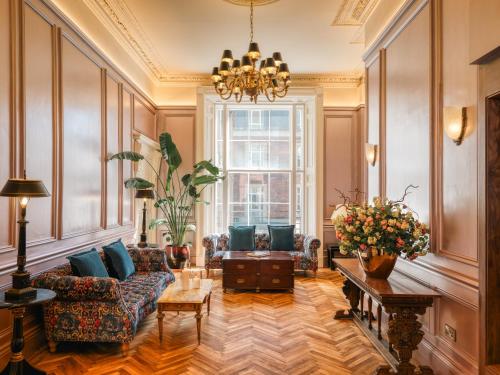 a living room with a couch and a chandelier at Albany Guest House in Dublin
