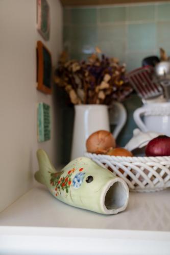 a figurine of a fish sitting on a counter at Villa d'Artiste en pleine pinède à 10 min d'Aix in Meyreuil