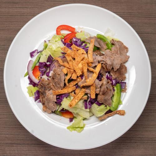 a plate of food with a salad on a table at Crowne Plaza Saint John Harbour View by IHG in Saint John