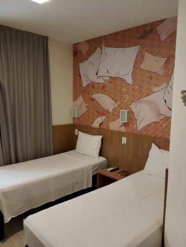 Postel nebo postele na pokoji v ubytování Hotel Cassino Tower Piracicaba by Nacional Inn