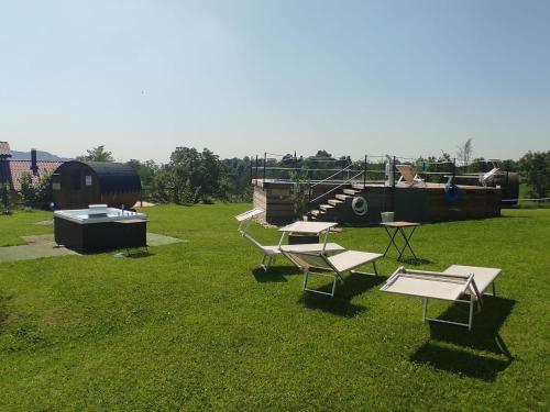 a group of picnic tables on a grass field at Agriturismo La Soglia Del Parco in Ranica