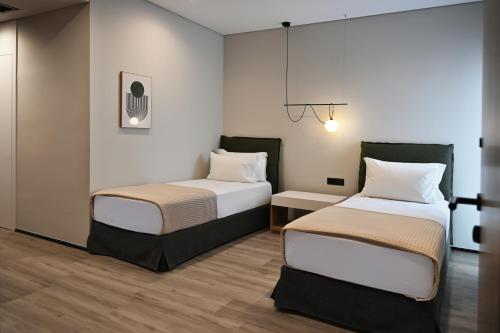 a room with two beds in a room at Asters Hotel in Ksamil