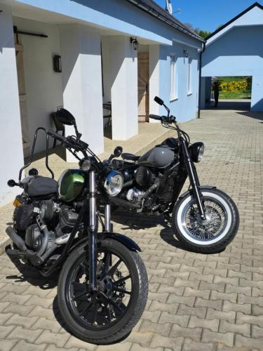 two motorcycles parked in front of a building at Apartmány Modrý Dom in Podhájska