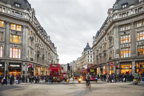 a busy city street with double decker buses and people at The Mandeville Hotel in London