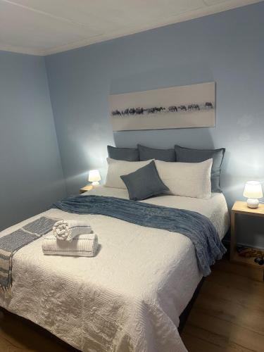 a bedroom with a large white bed with blue walls at Mario & Luiza's Place - Cozy Stay with Pool & Braai in Worcester