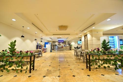 a banquet hall with tables and chairs and flowers at Abraj Al Tayseer Tuwa Hotel in Makkah