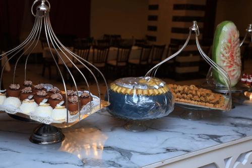 a table with a bunch of desserts on a table at Abraj Al Tayseer Tuwa Hotel in Makkah