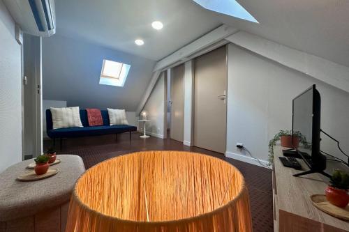 un salon avec une table et un canapé dans l'établissement Casa Foch - T3 pour 3 personnes - Parking - Proche Hyper Centre, à Brive-la-Gaillarde